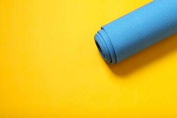 Sport mat folded into a roll, karemat for camping, on color background 