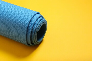 Sport mat folded into a roll, karemat for camping, on color background 