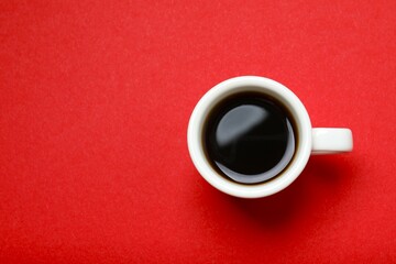 Cup of coffee on color background