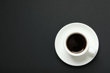 Cup of coffee on black background
