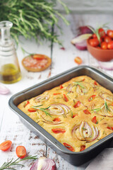 Italian home made bread focaccia with tomatoes and onions	