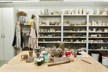 Comfortable pottery studio with table and pots.