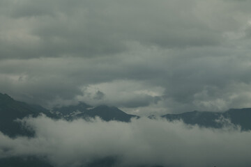 Misty mountains at dawn, shrouded in a soft veil, create a magical atmosphere of tranquility and mystery of nature