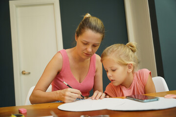  A mother and her young daughter engage in a colorful painting activity 