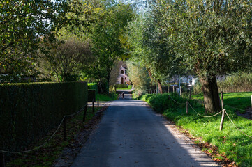 Lonely country road through the nature near the castle domains of Lennik, Flemish Brabant Region, Belgium, OCT 23, 2024