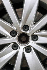 Background, texture of old, used titanium alloy wheel in car wheel. Close-up photo.