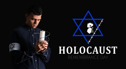 Young Jewish man with barbed wire and burning candle on black background. International Holocaust...