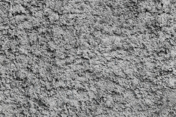 Background, texture of a gray uneven rough wall made of stone, cement.