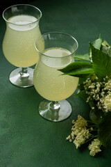 Carbonated elderflower drink. Flower summer kvass in glasses. Sparkling homemade hugo water. Elderberry food cook