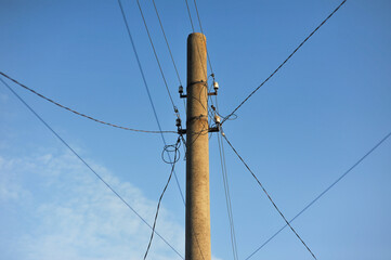 Concrete pole with cables, wires with electricity against the sky. Electricity concept.