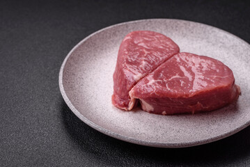 Ribeye steak raw with salt, spices and herbs