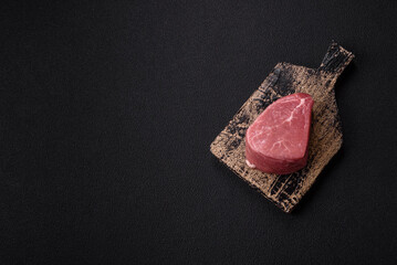 Ribeye steak raw with salt, spices and herbs