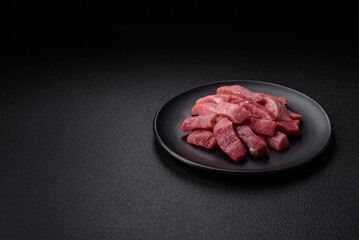 Juicy beef cut into slices with salt, spices and herbs