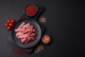 Juicy beef cut into slices with salt, spices and herbs