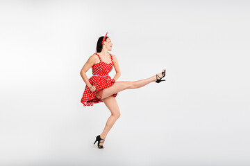 Full size photo of pretty girl raise leg enjoy dancing wear red retro style polka dot skirt...