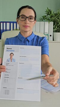 Business woman submits resume to employer for interview