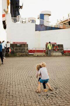 Two kids in front of a boat