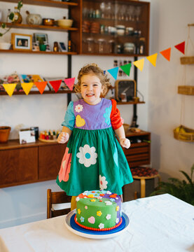 Very excited birthday girl with flower cake