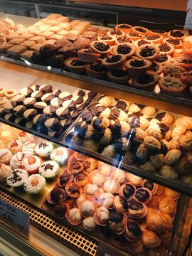 UGC Variety of Pastries and Desserts Displayed in a Bakery Case