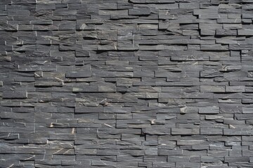 Wall made of cut slate stone.