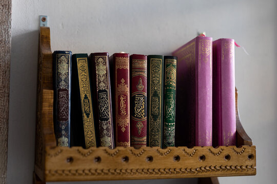 shelves in the mosque filled with a Quran