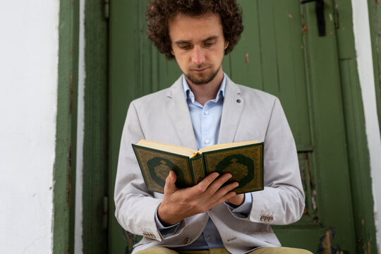 man holding and reading  Quran