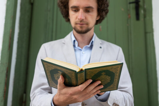 man holding and reading  Quran