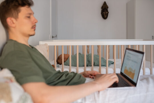Baby sleeping while father working - Powered by Adobe