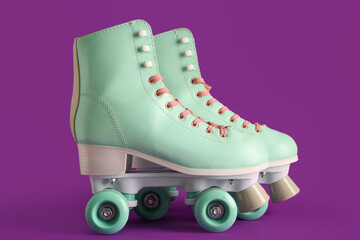 Pair of vintage roller skates on purple background