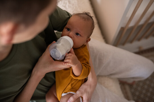 Father feeding newborn