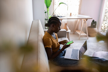 Woman using smartphone with green screen