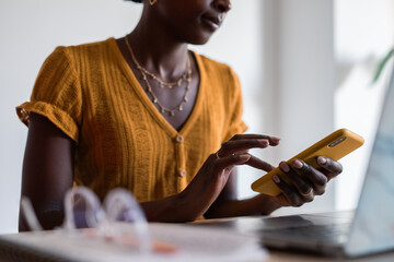 Woman using smartphone at workplace
