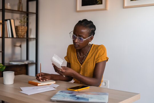 Serious woman counting expenses