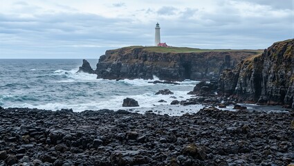 Icelandic coastline with black volcanic rocks crashing waves and distant lighthouse