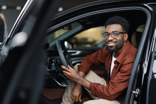 Prospective vehicle buyer posing while preparing for test drive