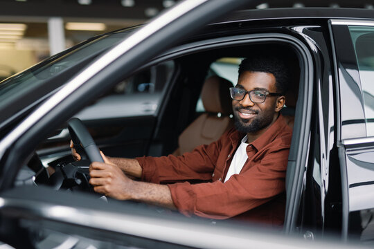 Smiling car dealership client getting ready for test drive