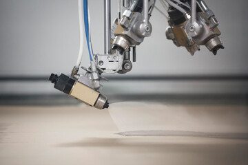 Close-up of industrial spray nozzles in operation of finishing

