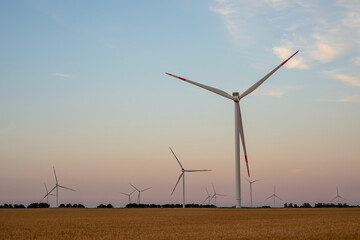 Windmills wind turbines farm power generators against in beautiful nature landscape for production...