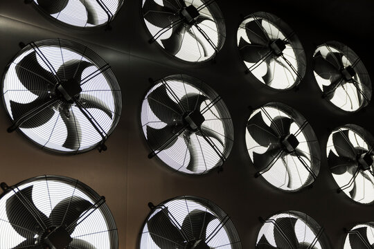 Industrial ceiling ventilation fans in a row