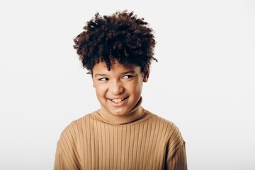 Smiling young african american girl posing gracefully against a clean white background in natural light and joyful expression