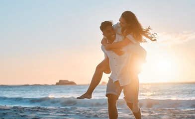 Piggyback, sunset or happy couple at beach to travel for love on vacation, valentines day or holiday. Sun flare, adventure or people in Spain for bonding together for romantic trip on tropical island