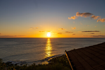 A stunning sunset over the pacific ocean of the coast of the island of Oahu in Honolulu Hawaii USA