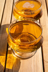 Tasting of french apple cider brut in glass made from new harvest apples outdoor in sunny orchard