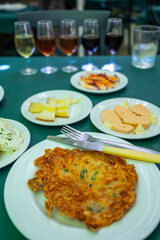 Traditional Andalusian dish from potato and seafood, Tortillitas de Camarones, Shrimp Fritters served with sherry wine  in old tavern as tapas, Sanlucar de Barrameda, Spain