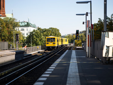 BERLIN, GERMANY - 23. September 2024: U1 U-Bahn train arriving at the station G&ouml;rlitzer Bahnhof. Yellow subway on the rails entering the platform. Public transport in the Kreuzberg district.