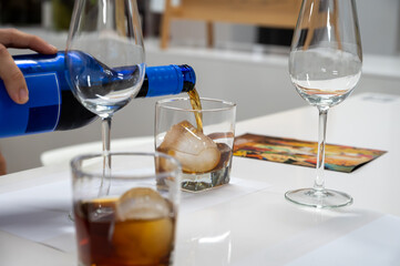 Tasting Sherry sweat cream wine on ice rocks, jerez fortified wine made from palomino white grape...