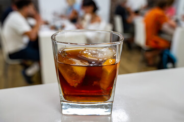 Tasting Sherry sweat cream wine on ice rocks, jerez fortified wine made from palomino white grape...