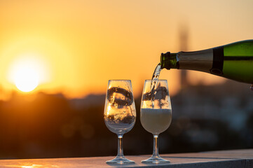 Drinking of cava or champagne sparkling wine on outdoor roof terrace with view on central part of...