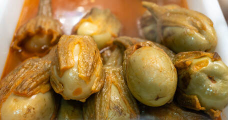 Pickled and marinated mini eggplants vegetables on farmers market, variety of tasty tapas in Andalusia, Spain
