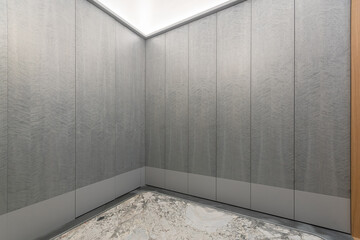 A fragment of the hallway, decorated in gray tones. Spacious built-in wardrobes with .a concise...